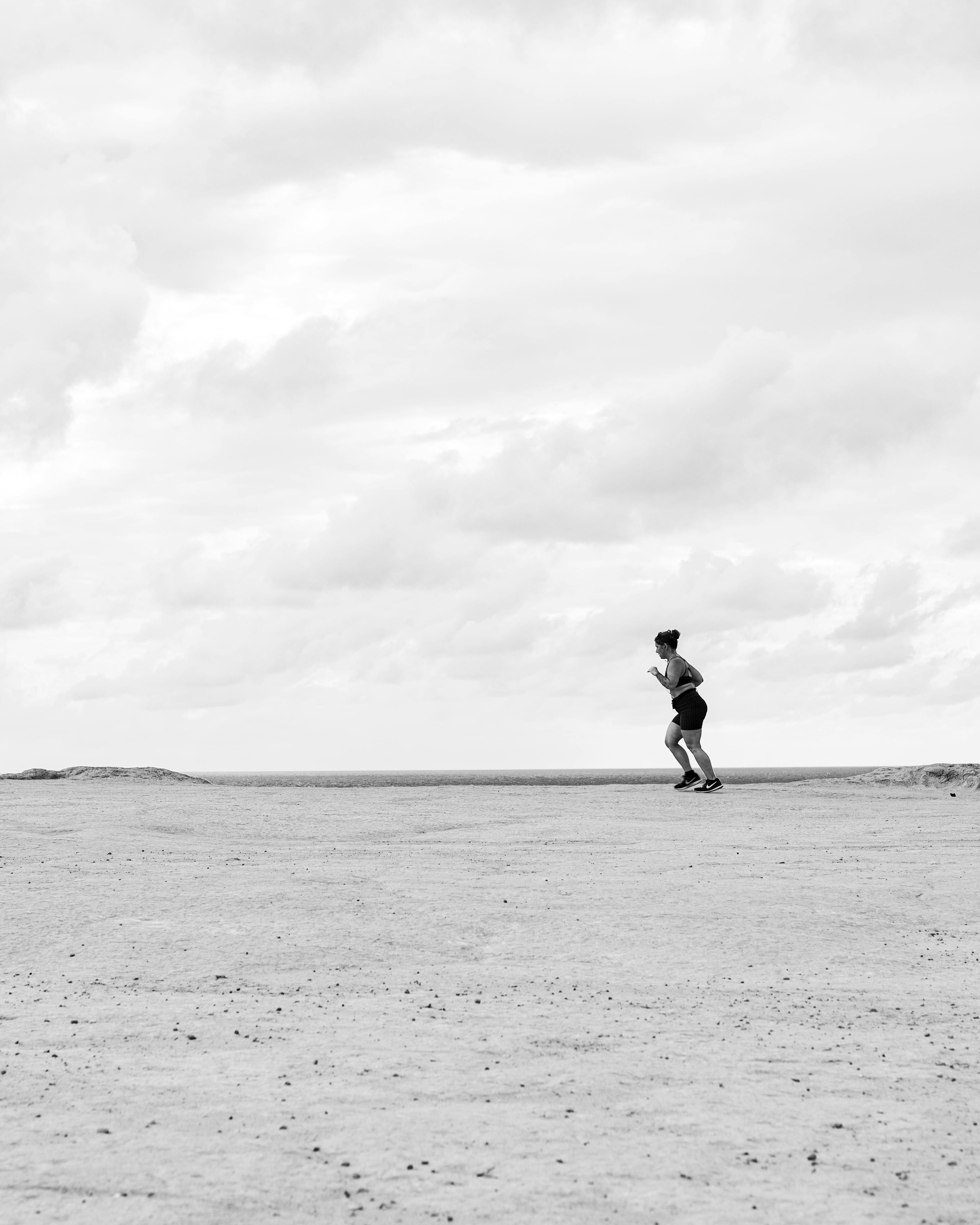 Woman Running Across Open Plain