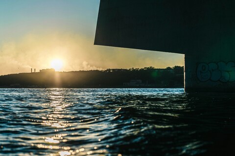 Sunset Under Bridge Over Water