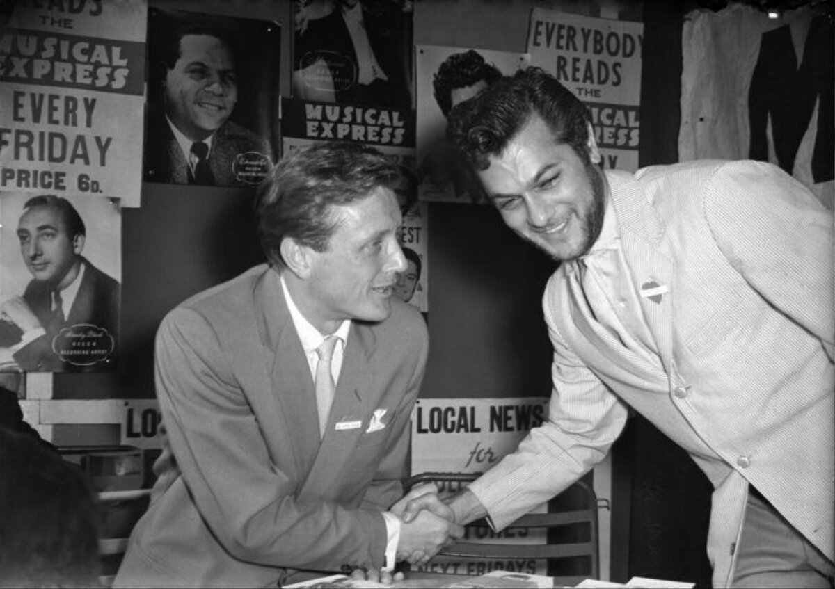 Two Men Shake Hands At Musical Express Event