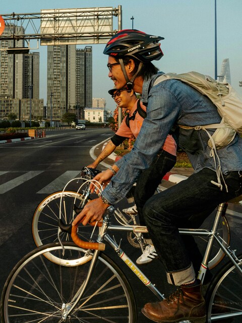 Two Men Cycling on Urban Road