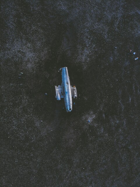 Abandoned Plane Wreckage on Black Sand