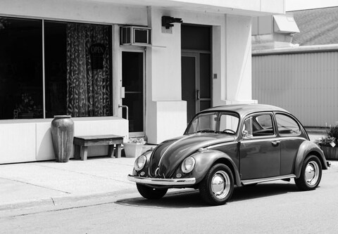 Vintage Beetle Parked Outside Storefront