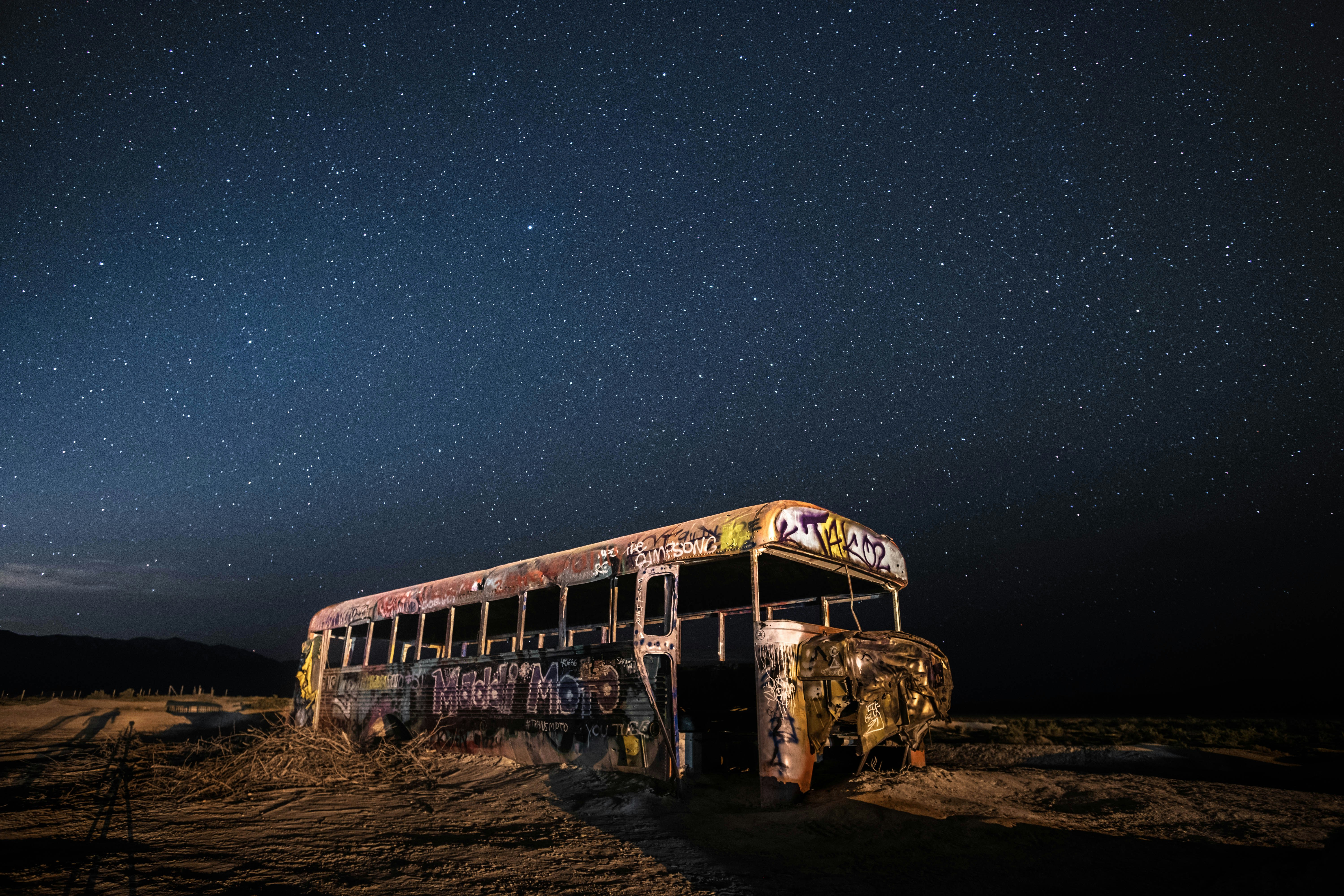 Abandoned Bus Under Starry Desert Night