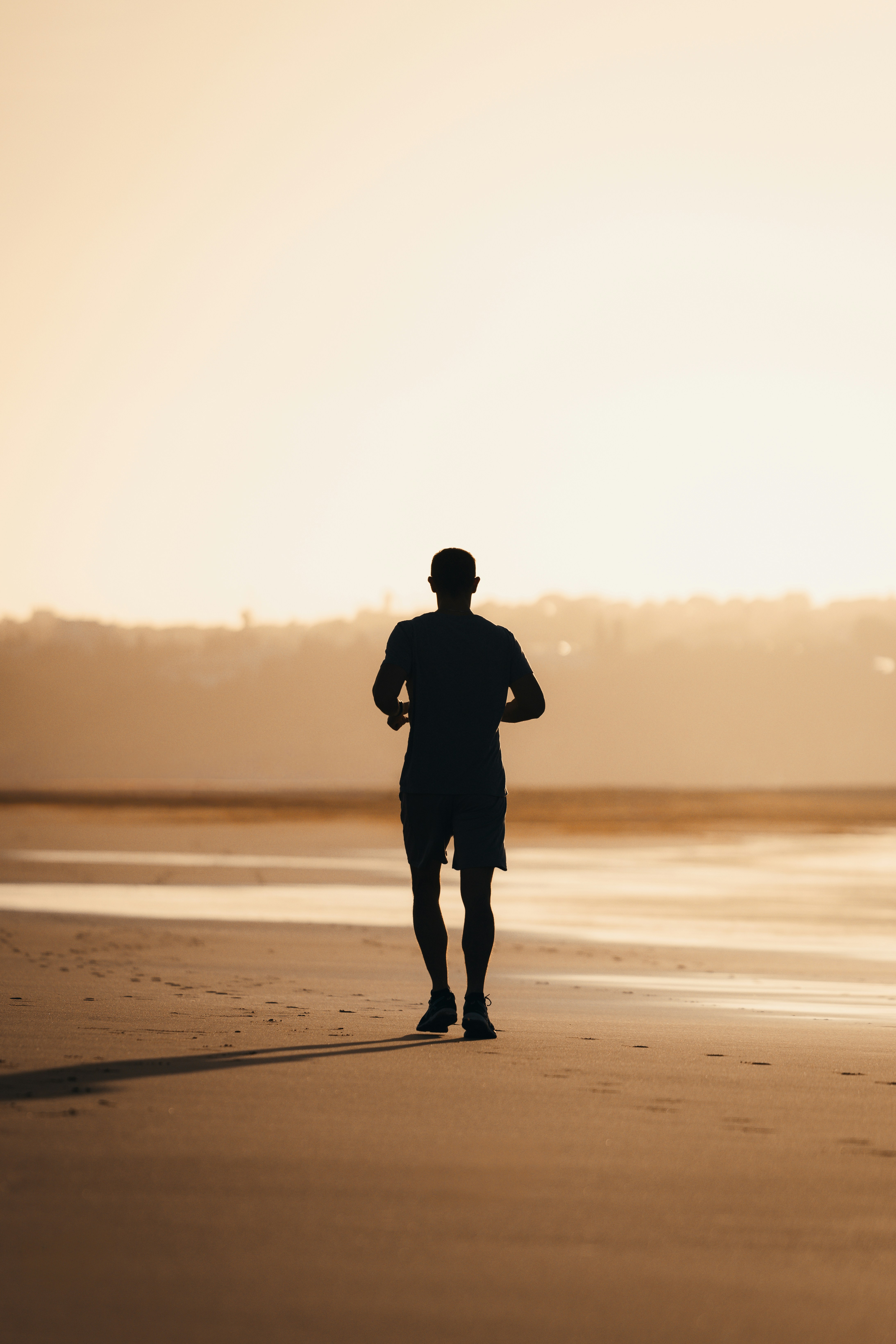 Jogger Silhouette on Beach at Sunset