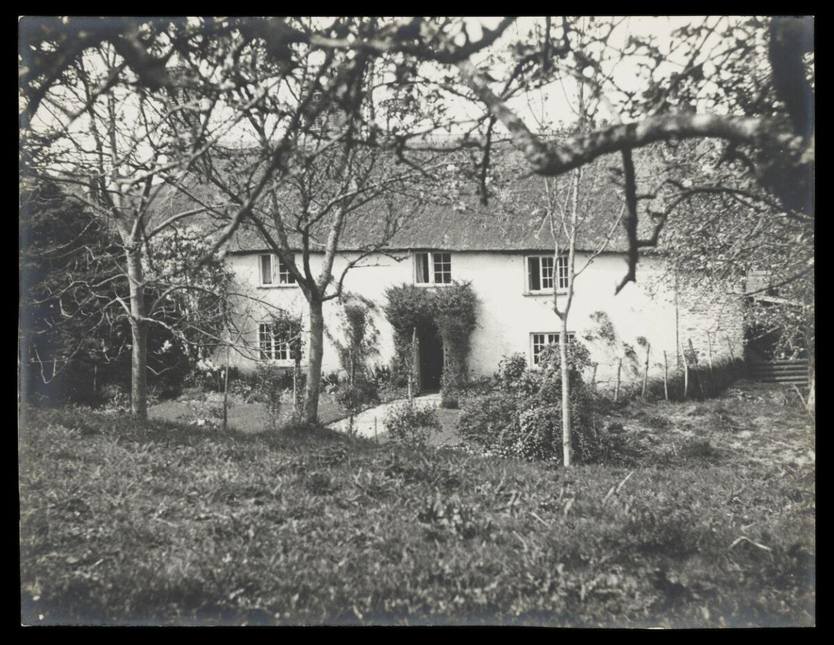 Thatched Cottage Through Orchard Trees