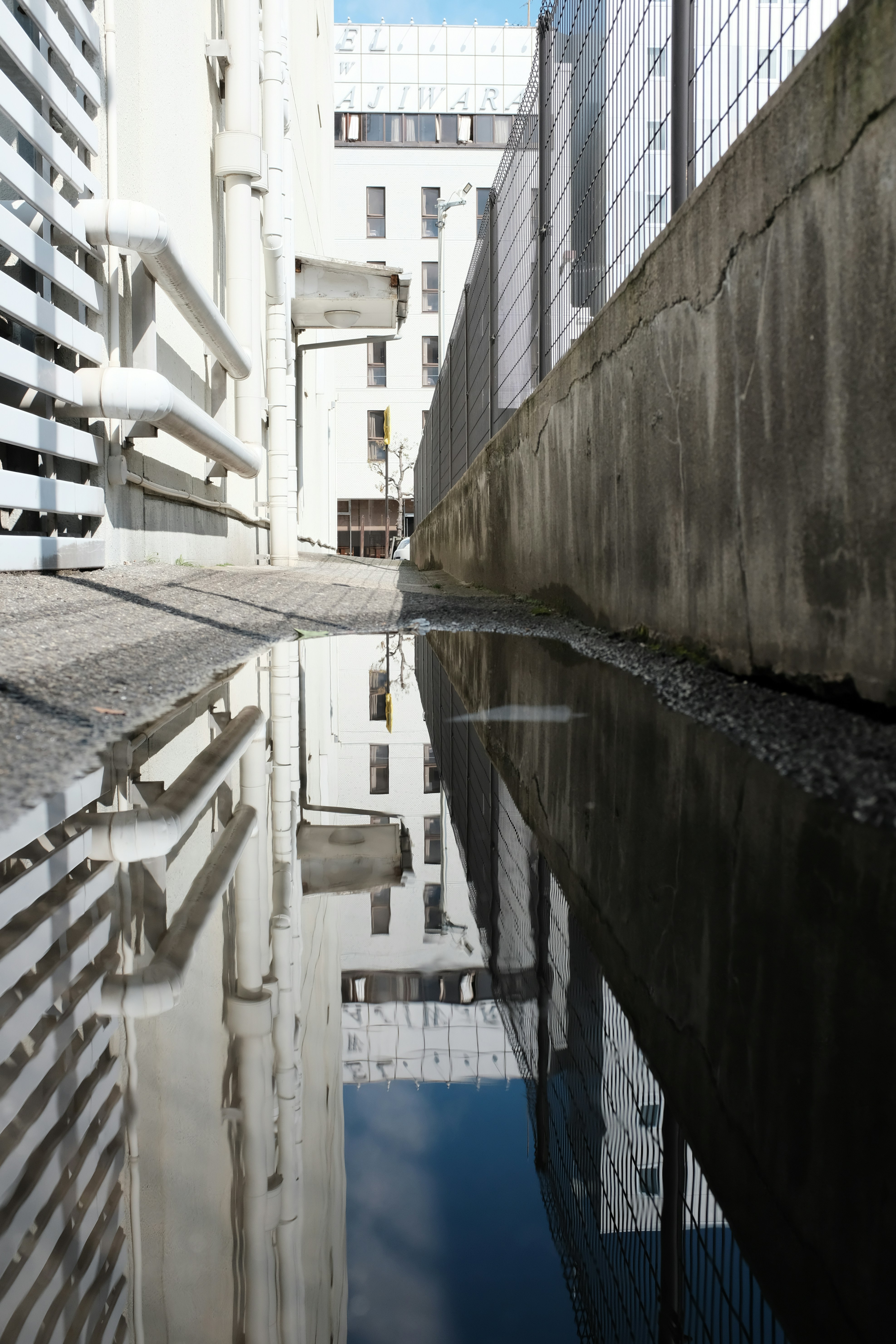 Urban Alley Puddle Reflection