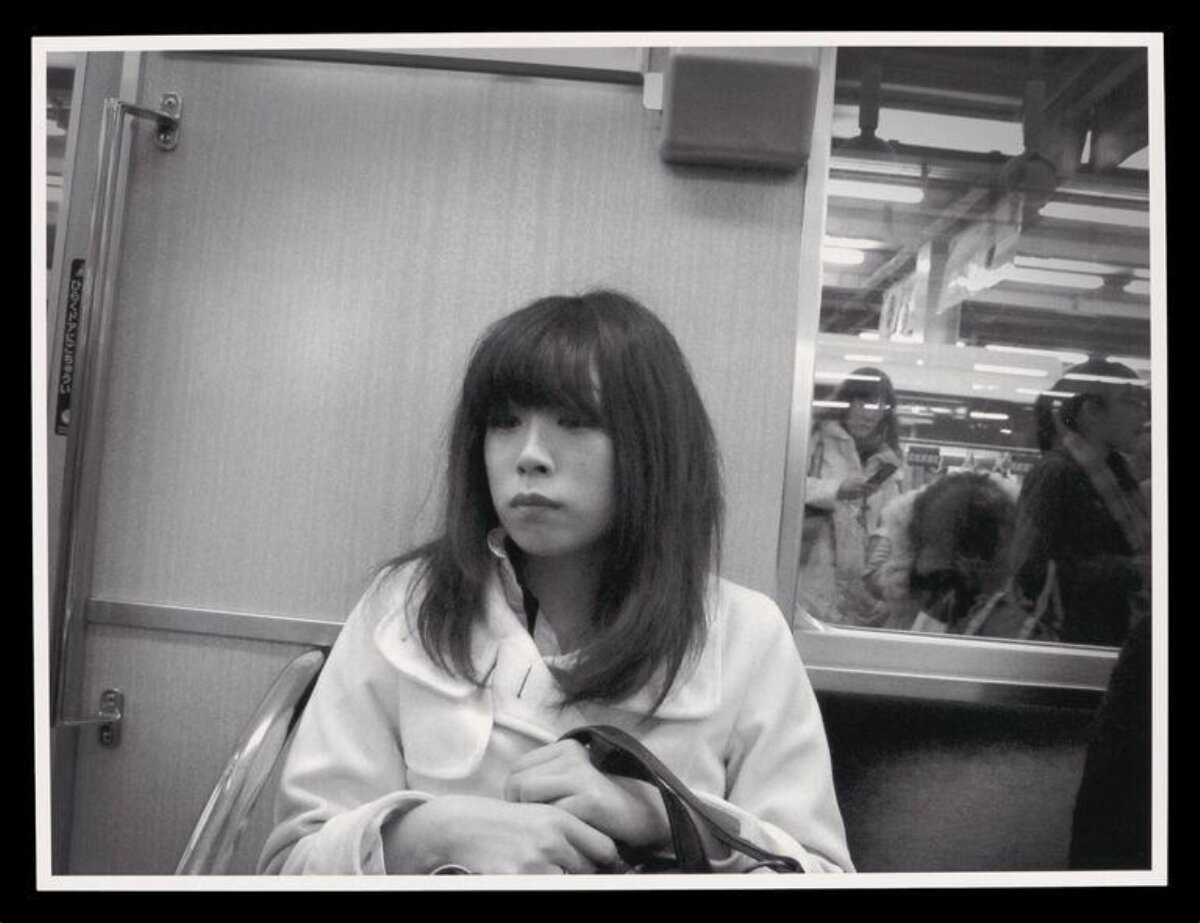 Woman Sitting on Subway Train