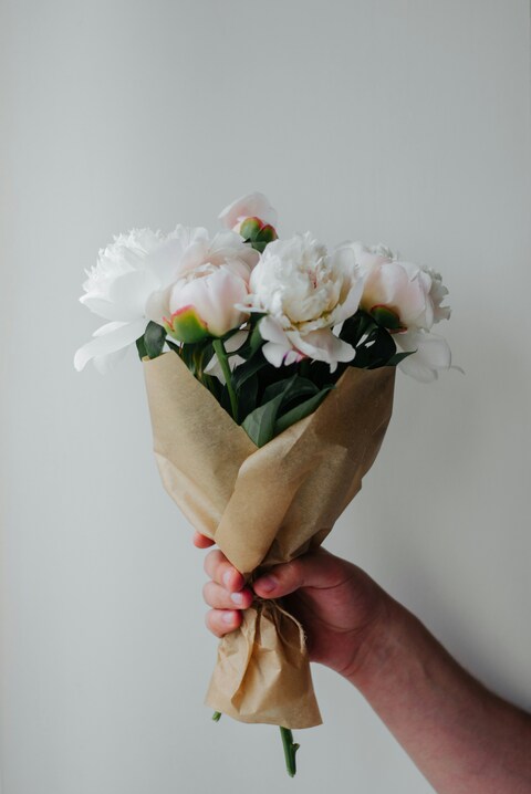 Hand Holding White Peony Bouquet