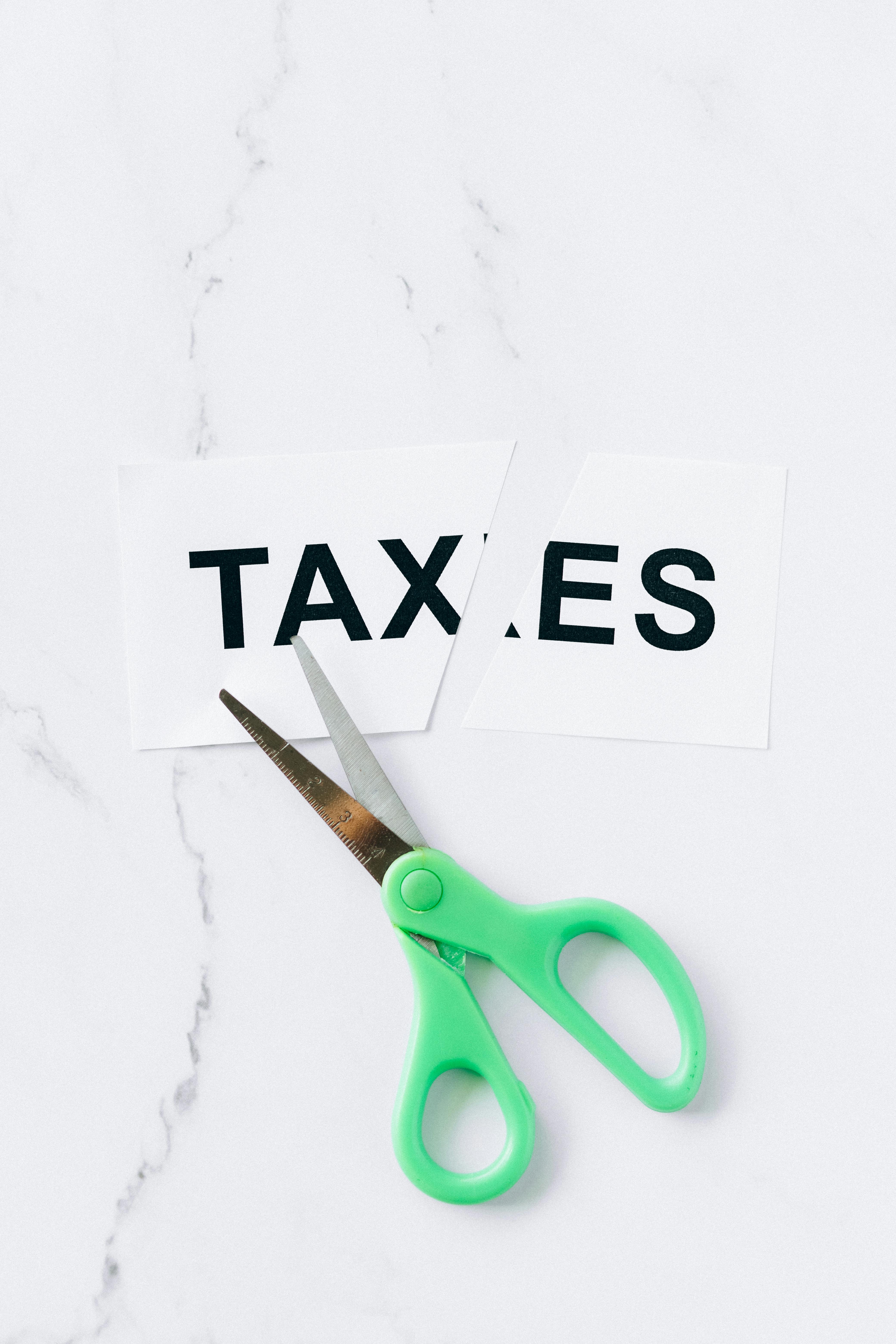 Scissors Cutting the Word Taxes