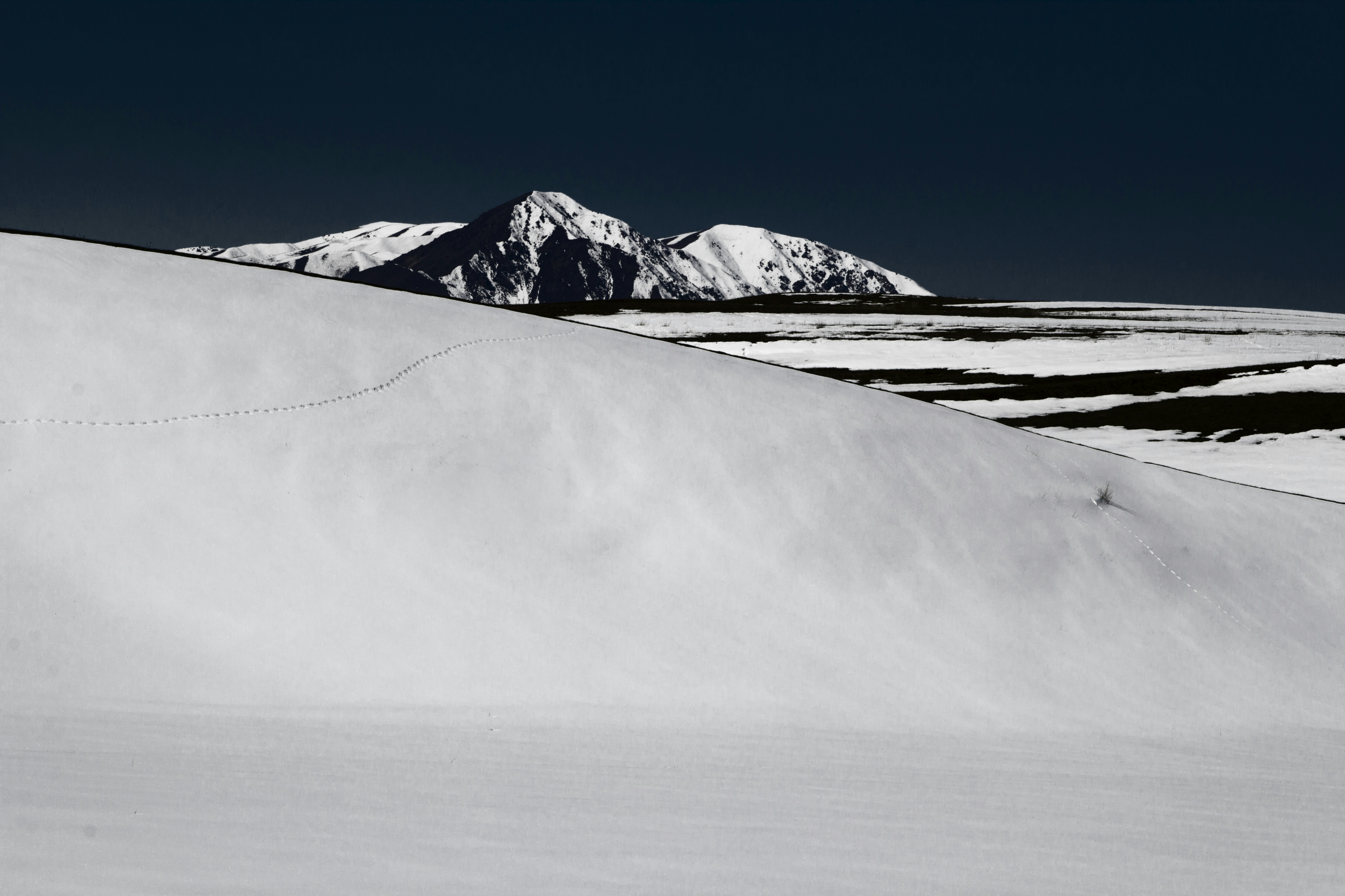 Snowy Hills and Distant Peaks
