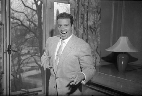 Laughing Man In Suit By Window