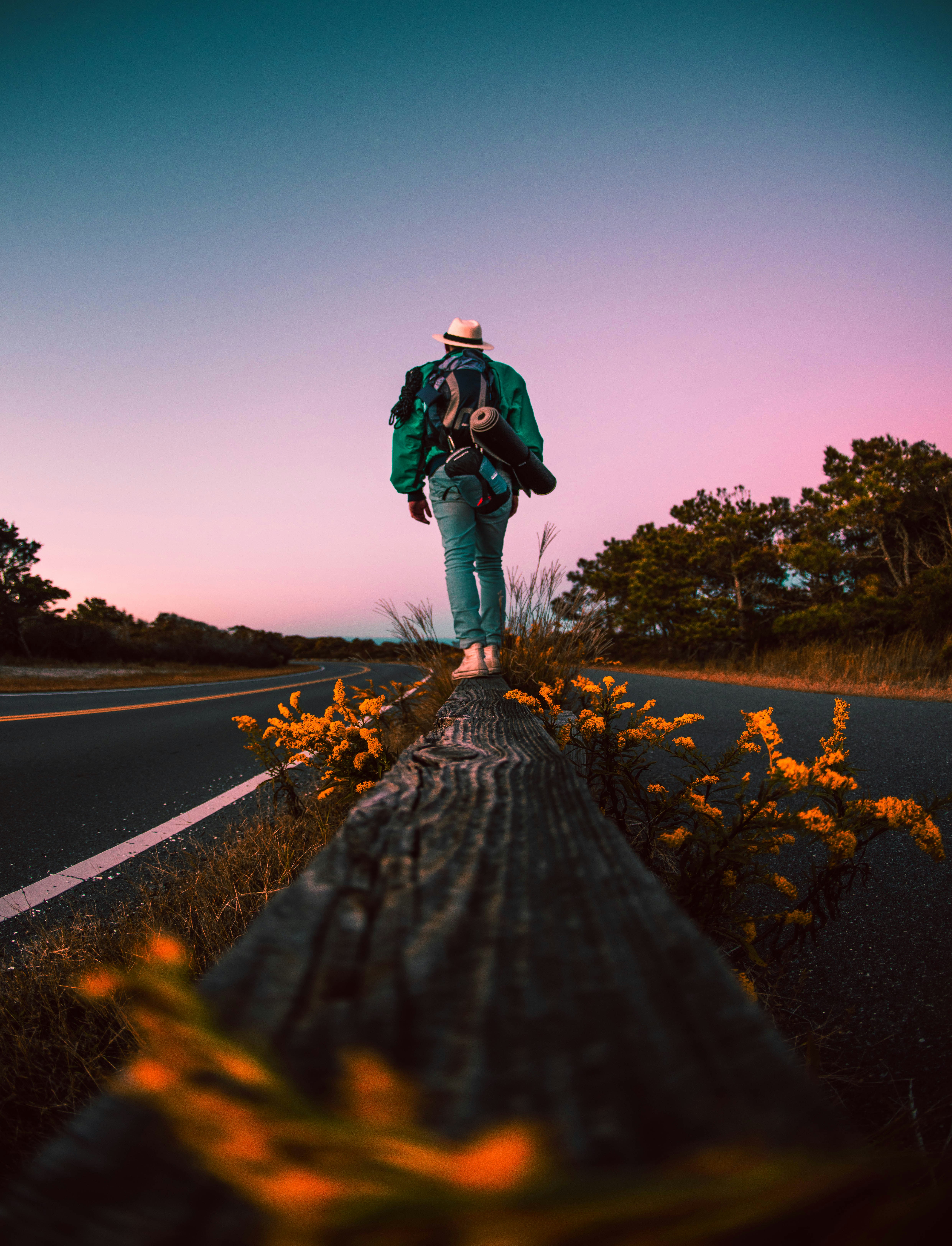 Backpacker on Roadside Guardrail