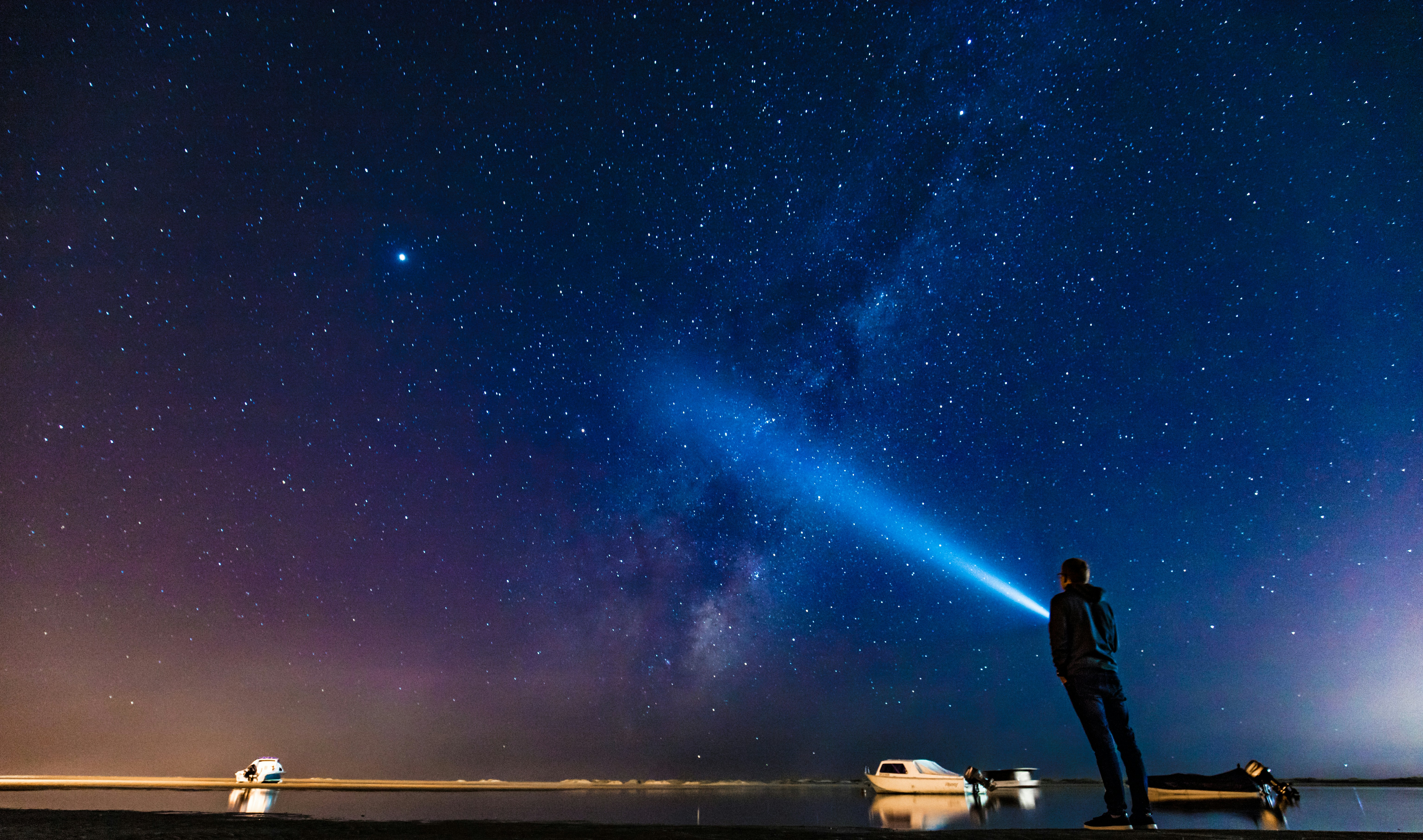 Man Gazing at Starry Sky by Water