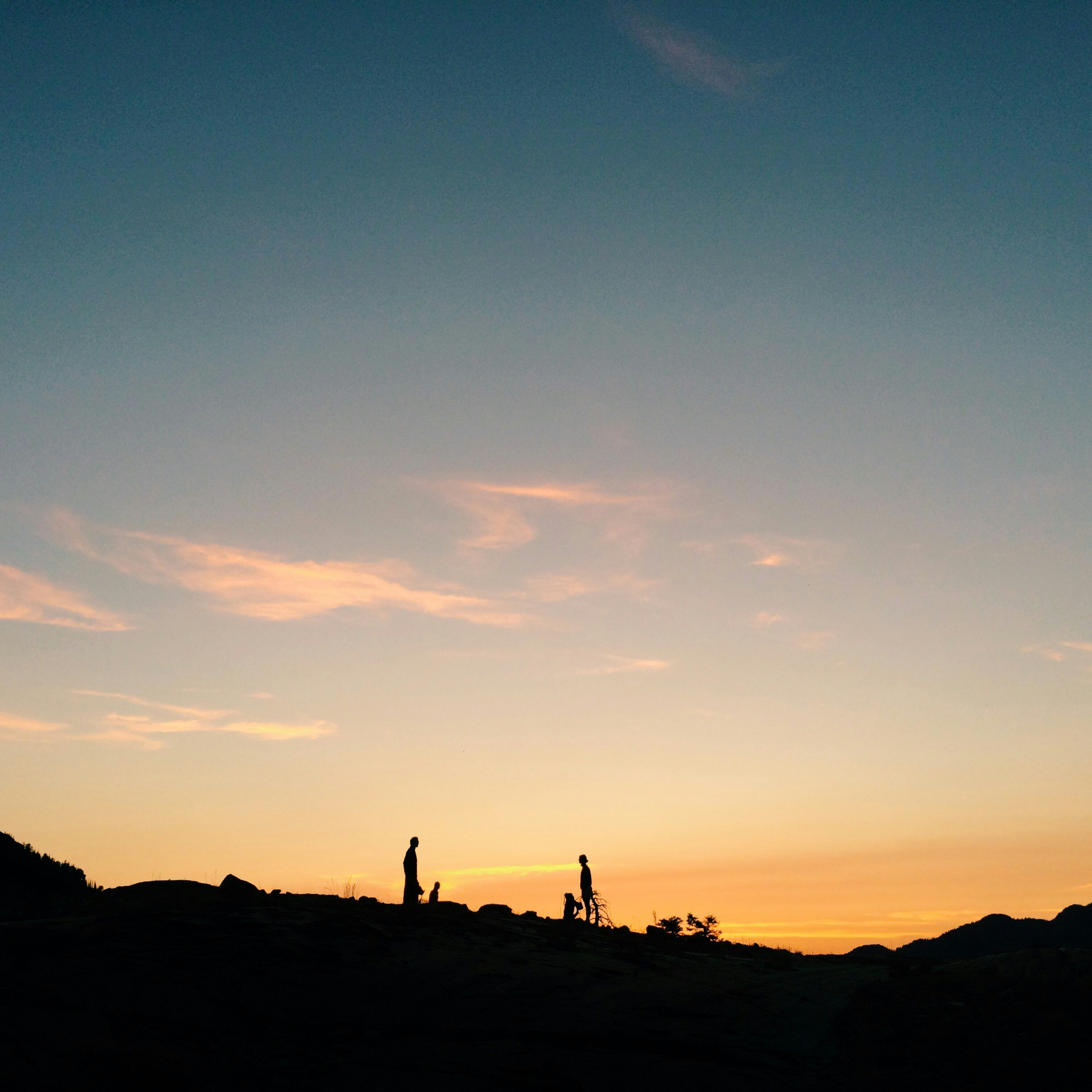 Silhouettes of People at Hilltop Sunset