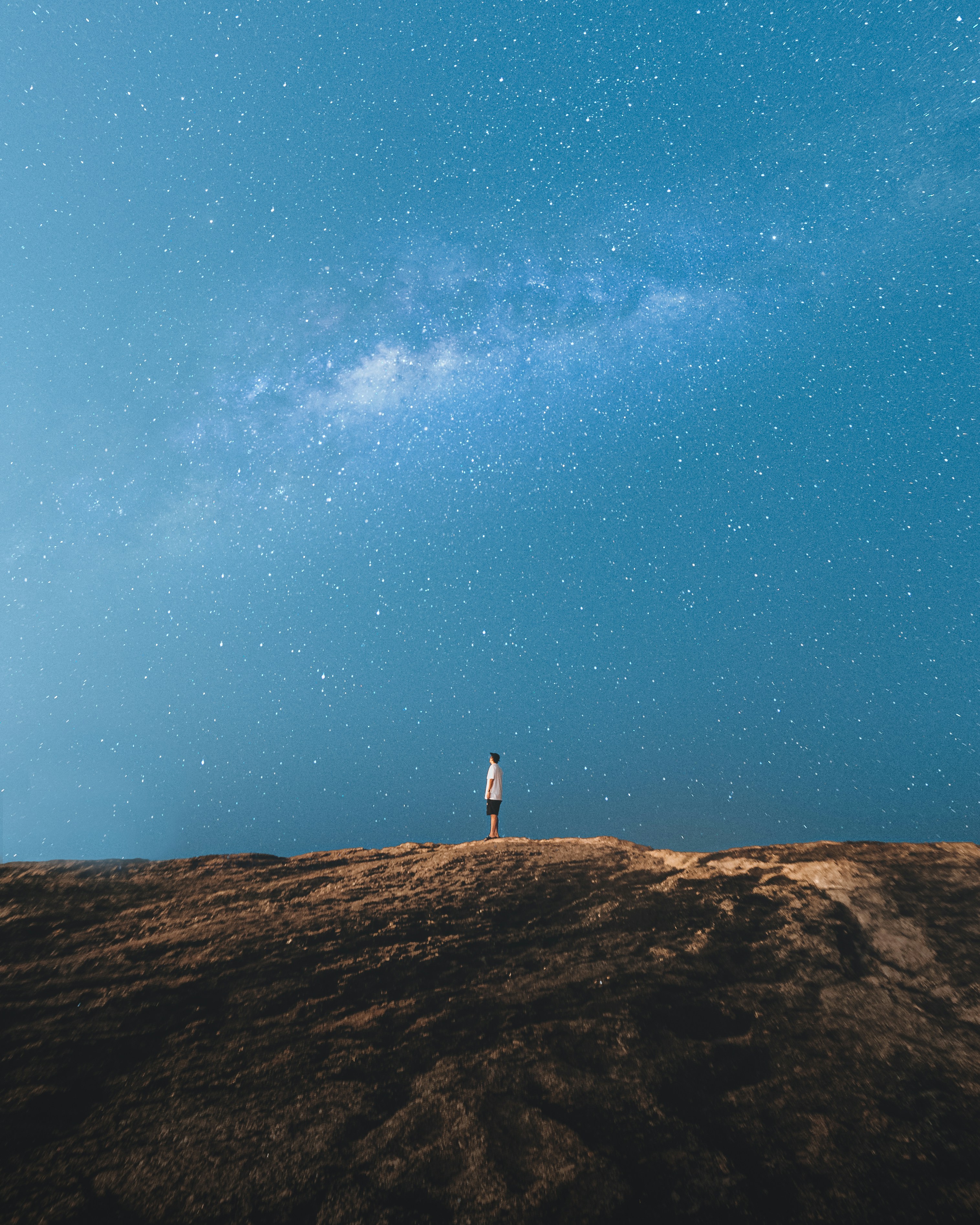 Man Standing Alone Under Starry Sky