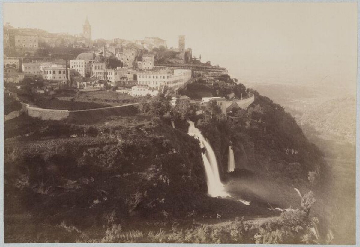 Cliffside Town Waterfall View