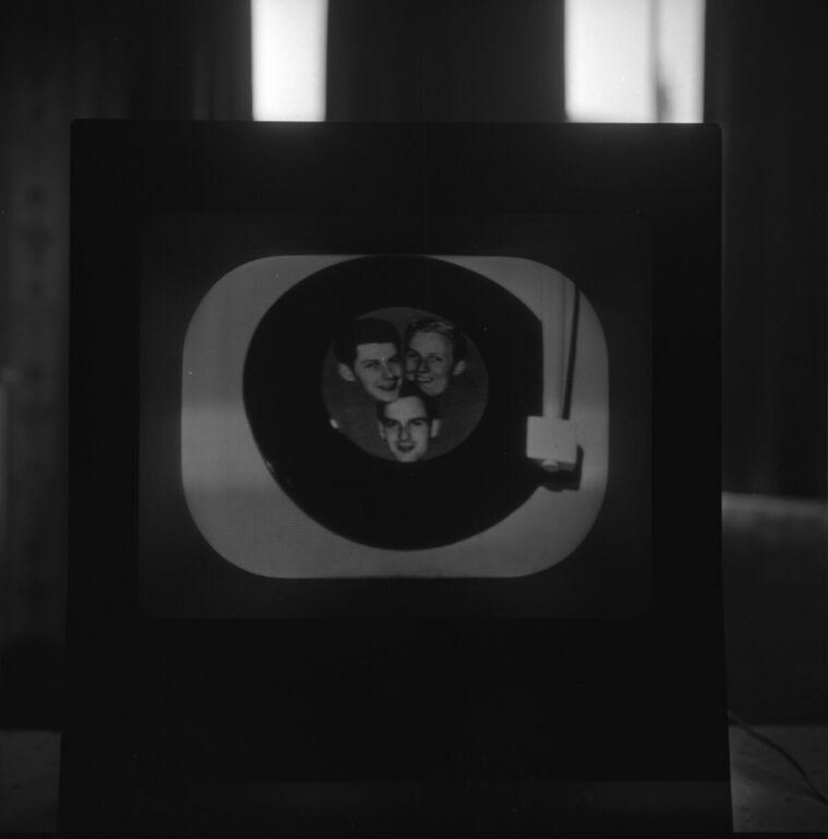 Three Faces in Recursive Tunnel on TV Screen