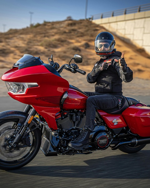 Man Riding Red Harley-Davidson Motorcycle