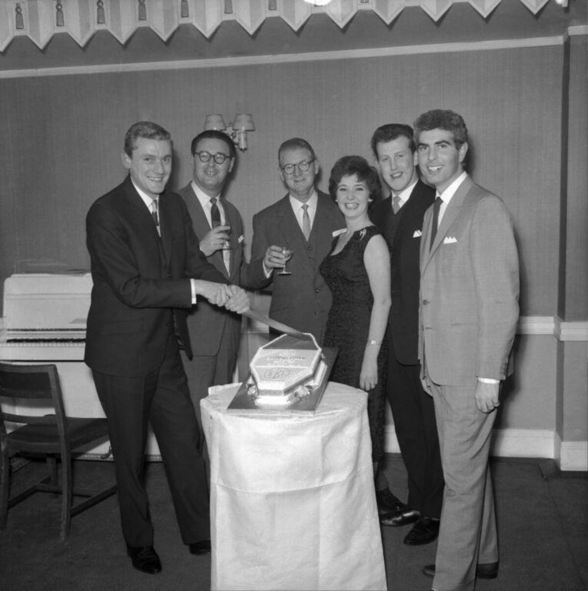 Group Cutting Celebration Cake