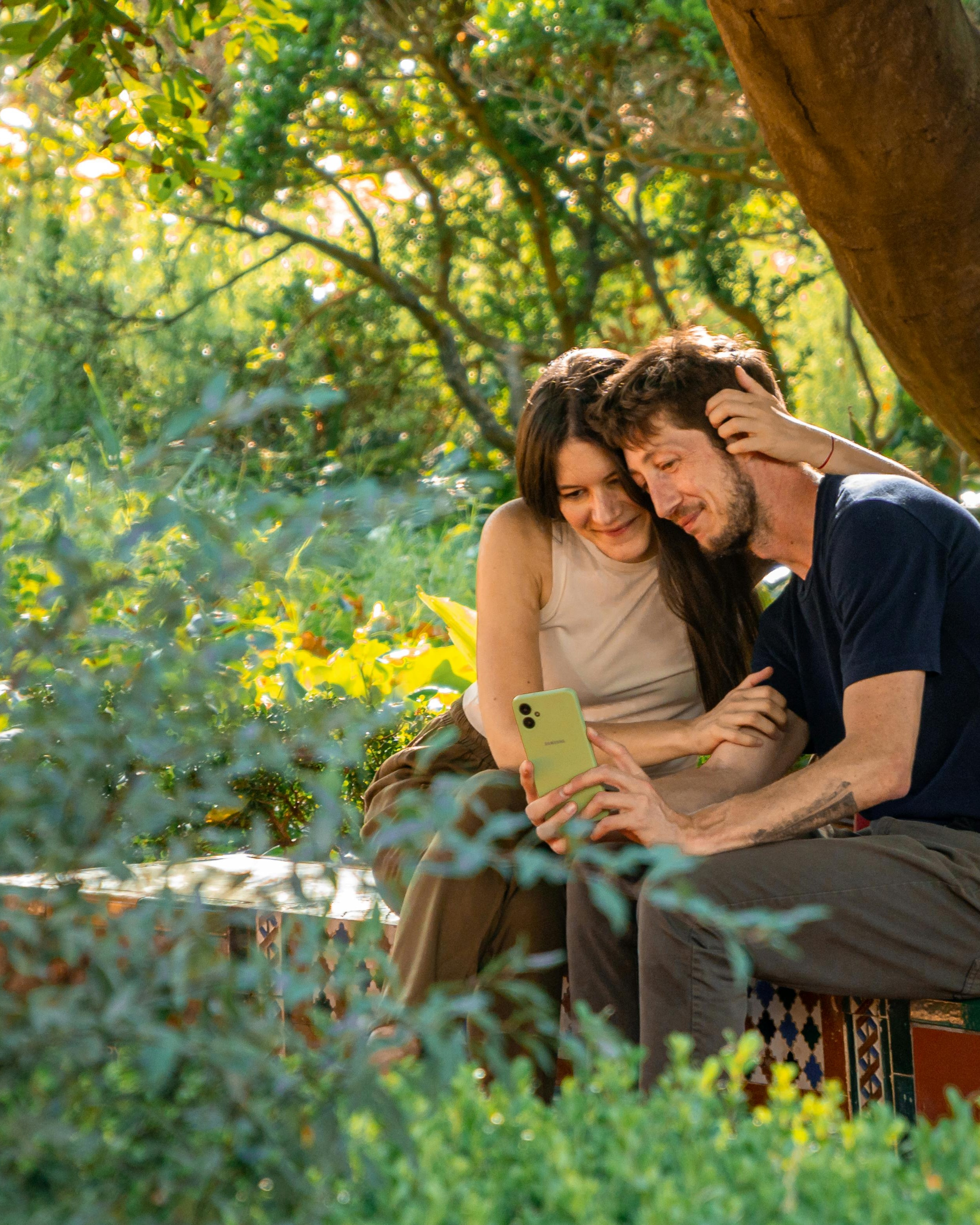 Couple Viewing Phone in Garden