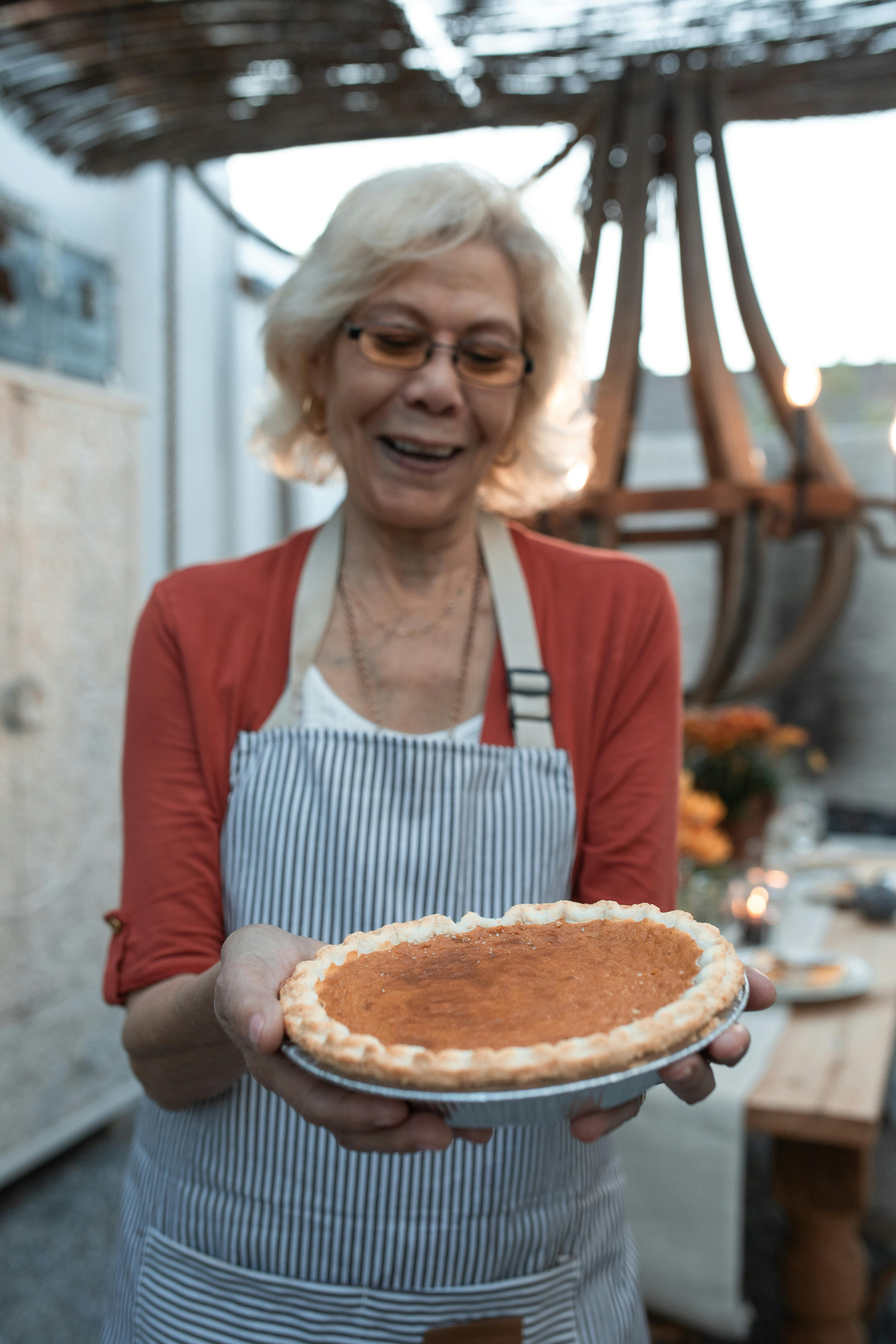 Senior Woman Holding Homemade Pie