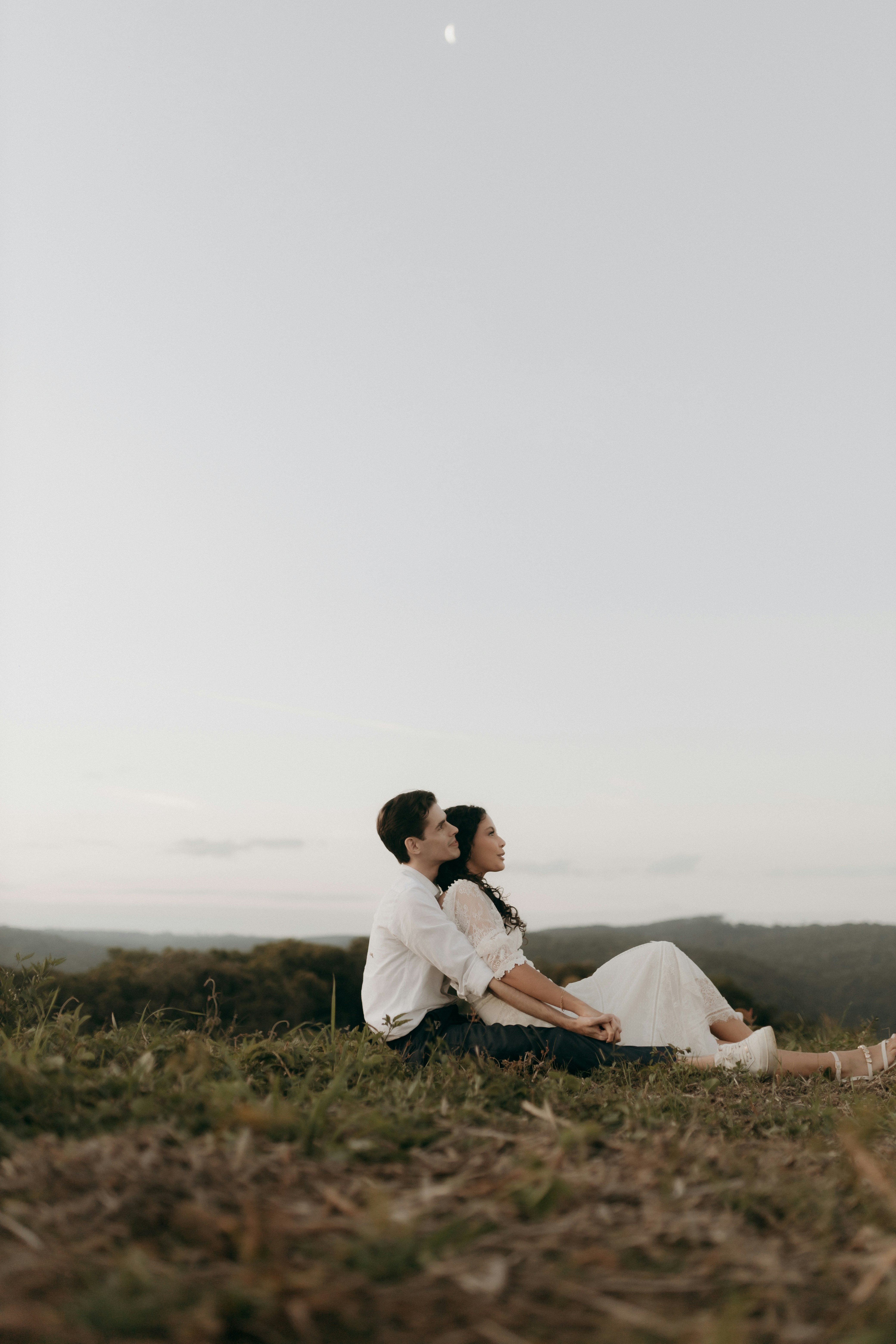 Couple Sitting on Hilltop Overlook