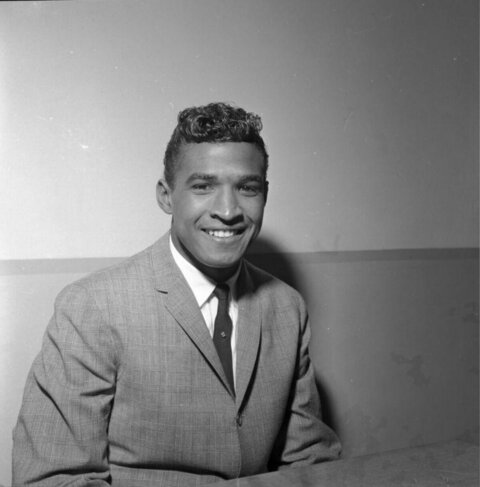 Smiling Young Man in Checkered Suit