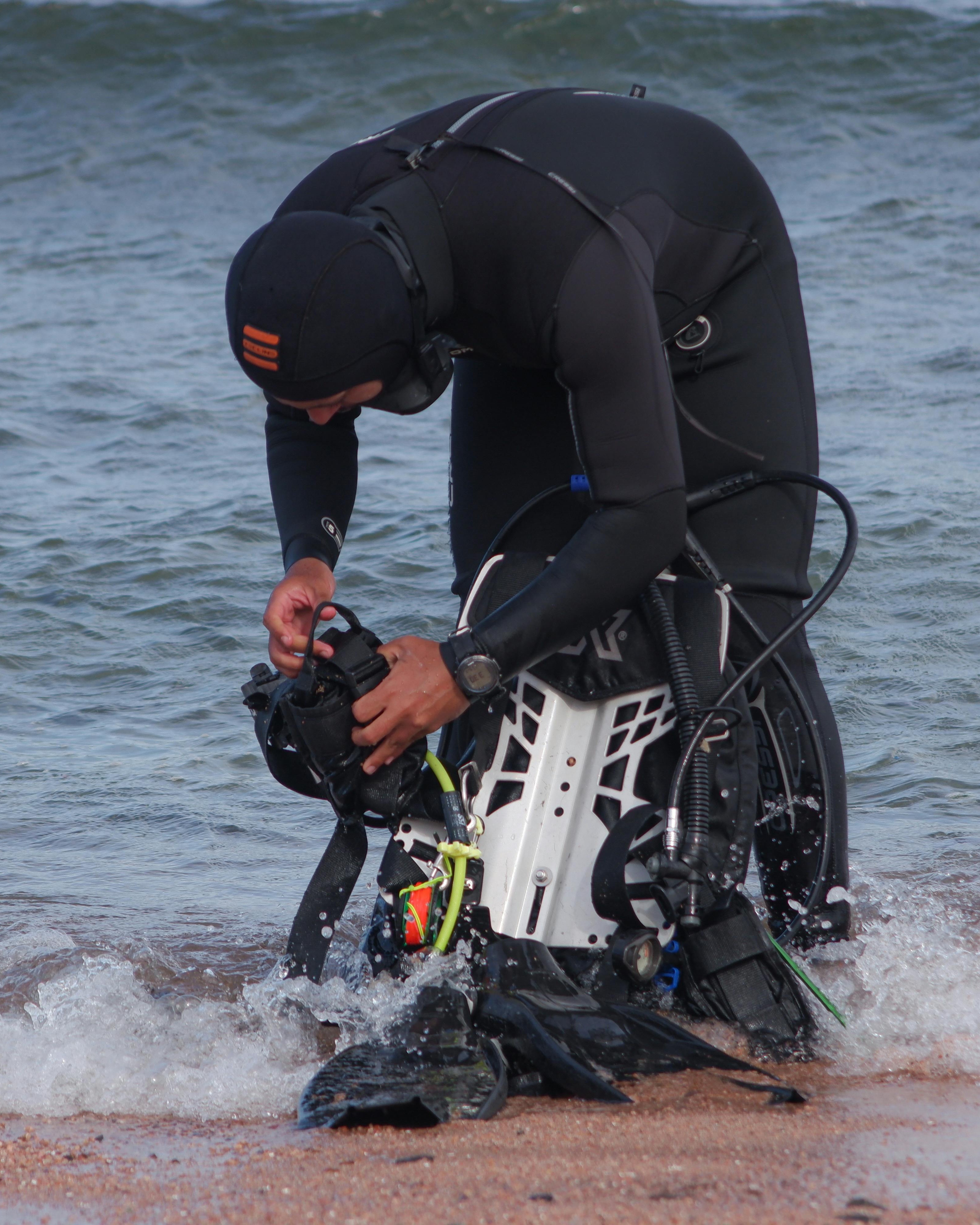 Diver Preparing Scuba Gear at Shore