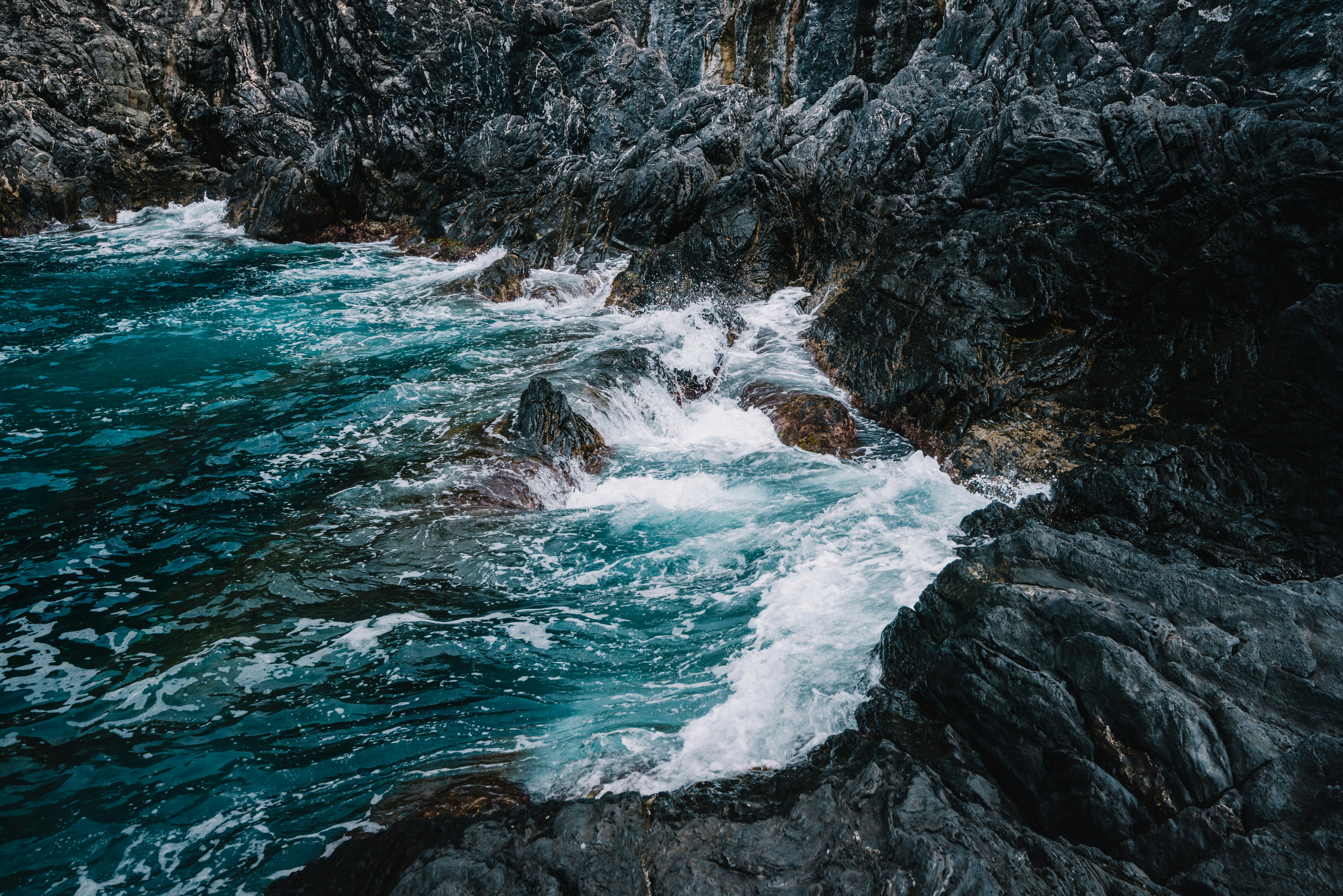 Turbulent Waves on Dark Rocky Coast