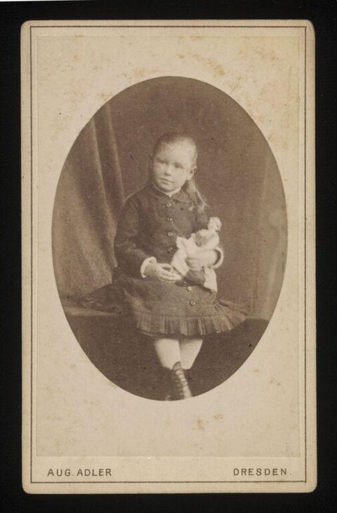 Vintage Portrait of Child Holding Doll