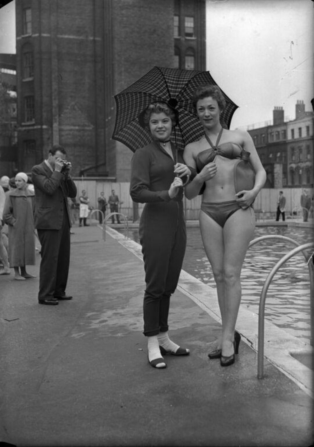 Two Women Posing At Outdoor Swimming Pool