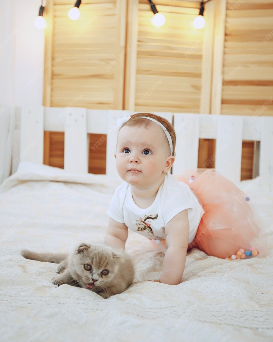 Baby Girl With Kitten On Bed