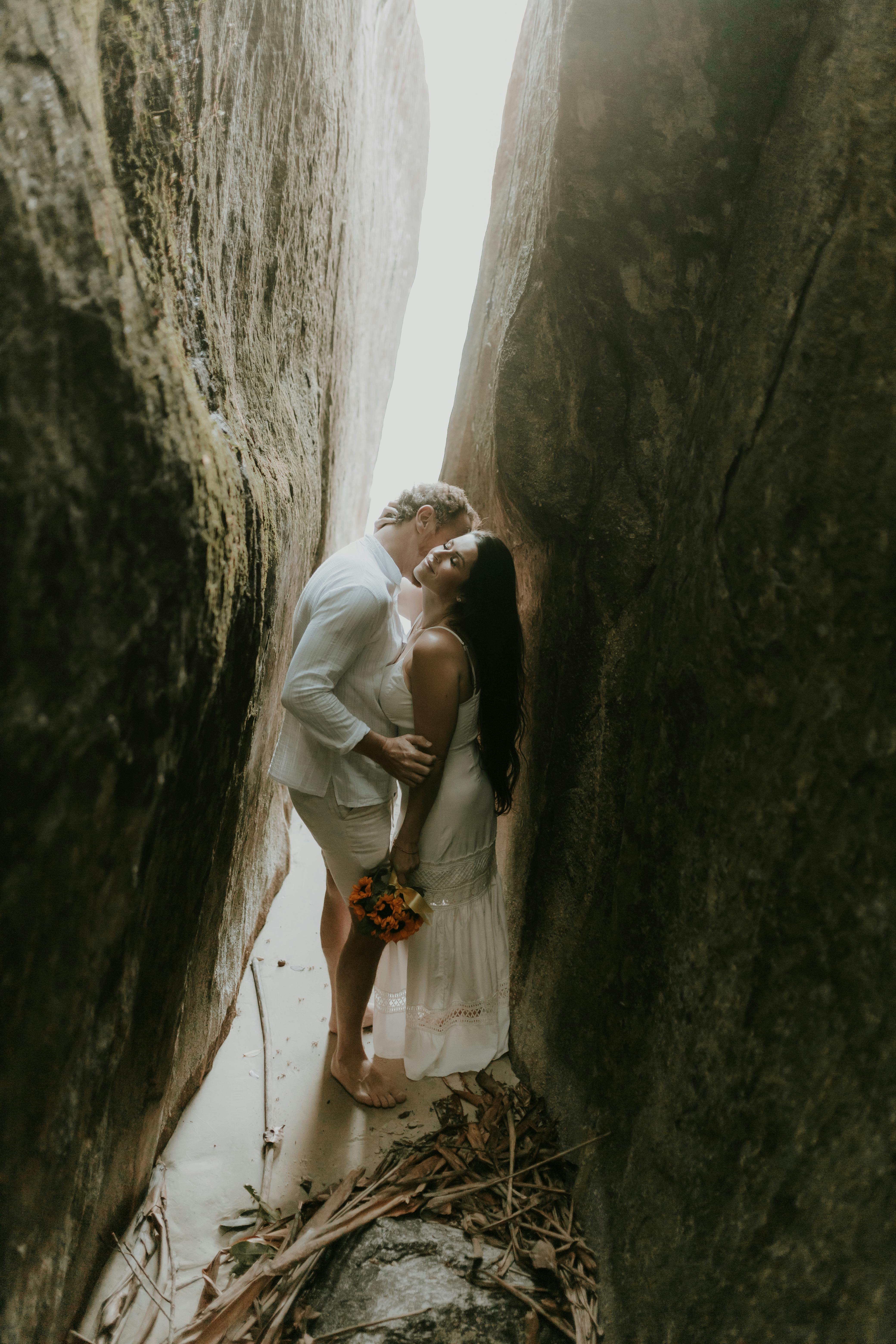 Couple Embracing in Narrow Rock Crevice