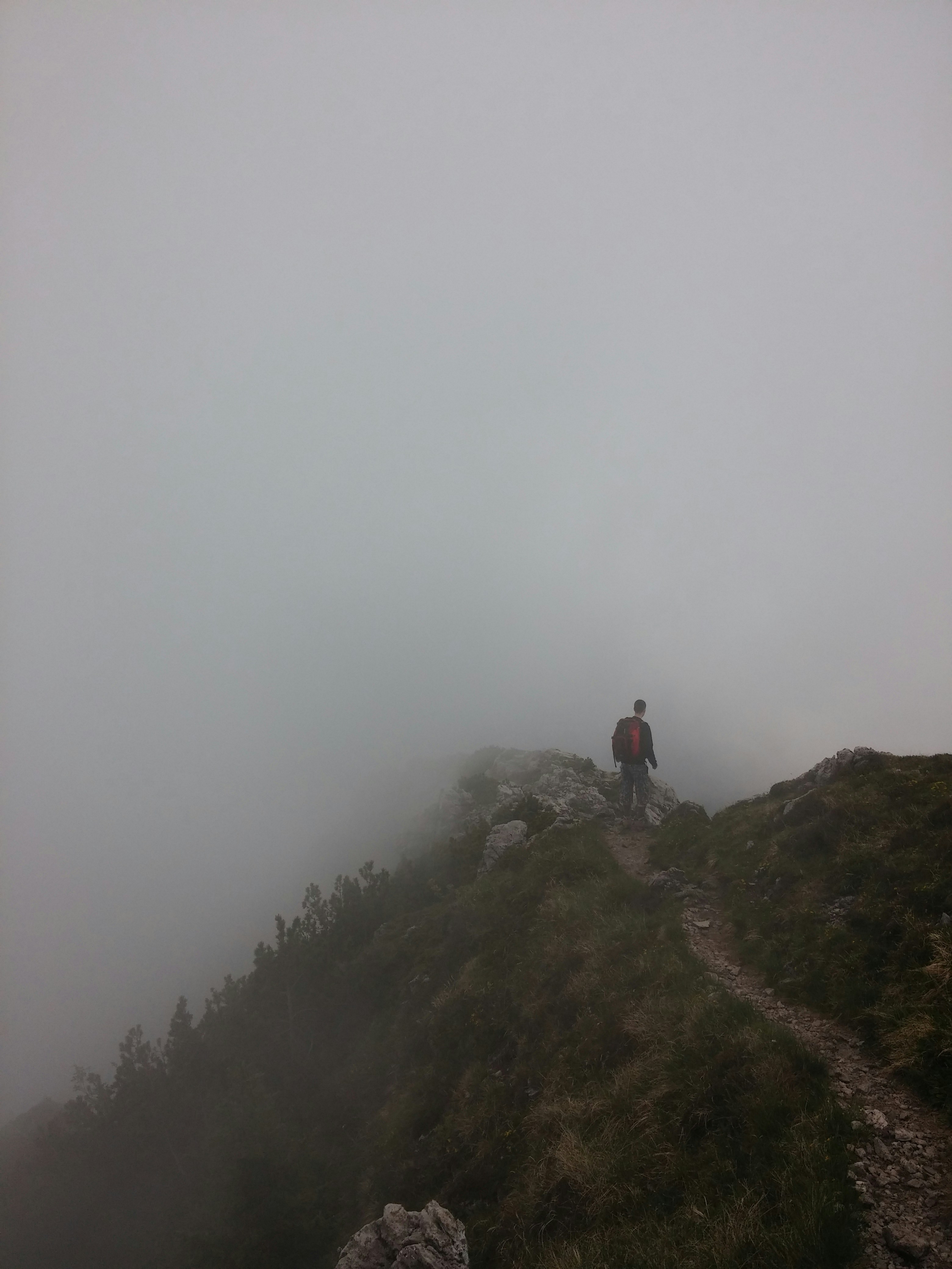 Hiker on Foggy Mountain Ridge