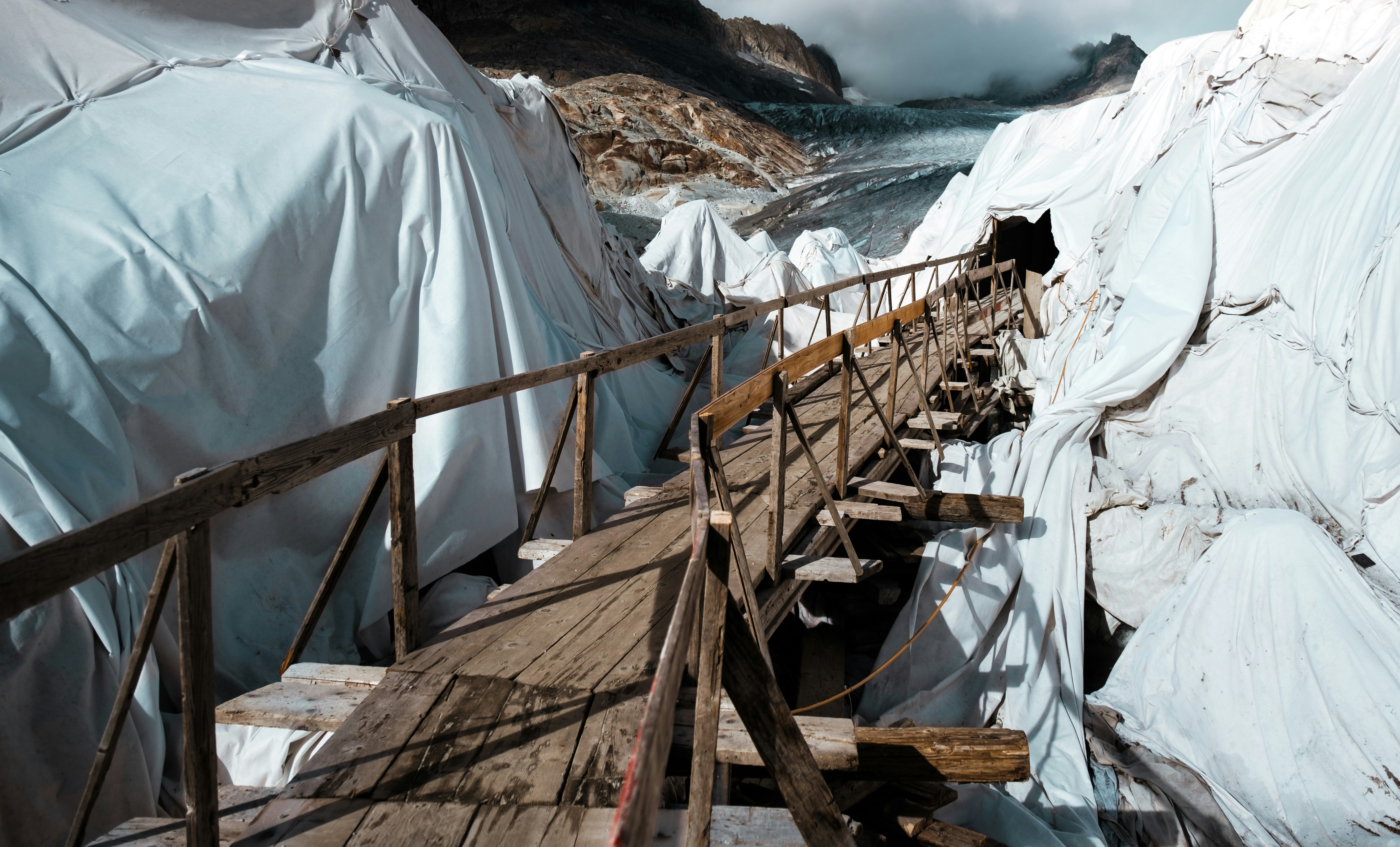Glaciers Covered by White Tarps with Wooden Bridge