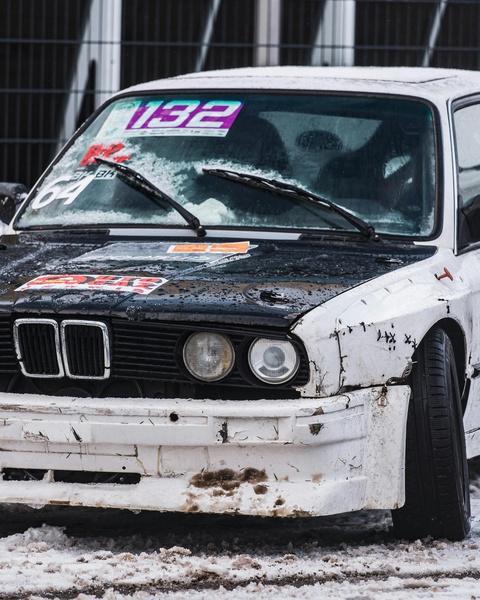 Damaged Race BMW on Snowy Ground