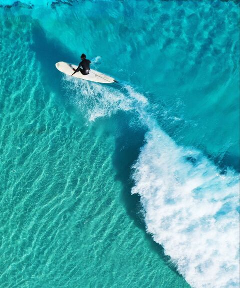 Surfer on Clear Turquoise Ocean