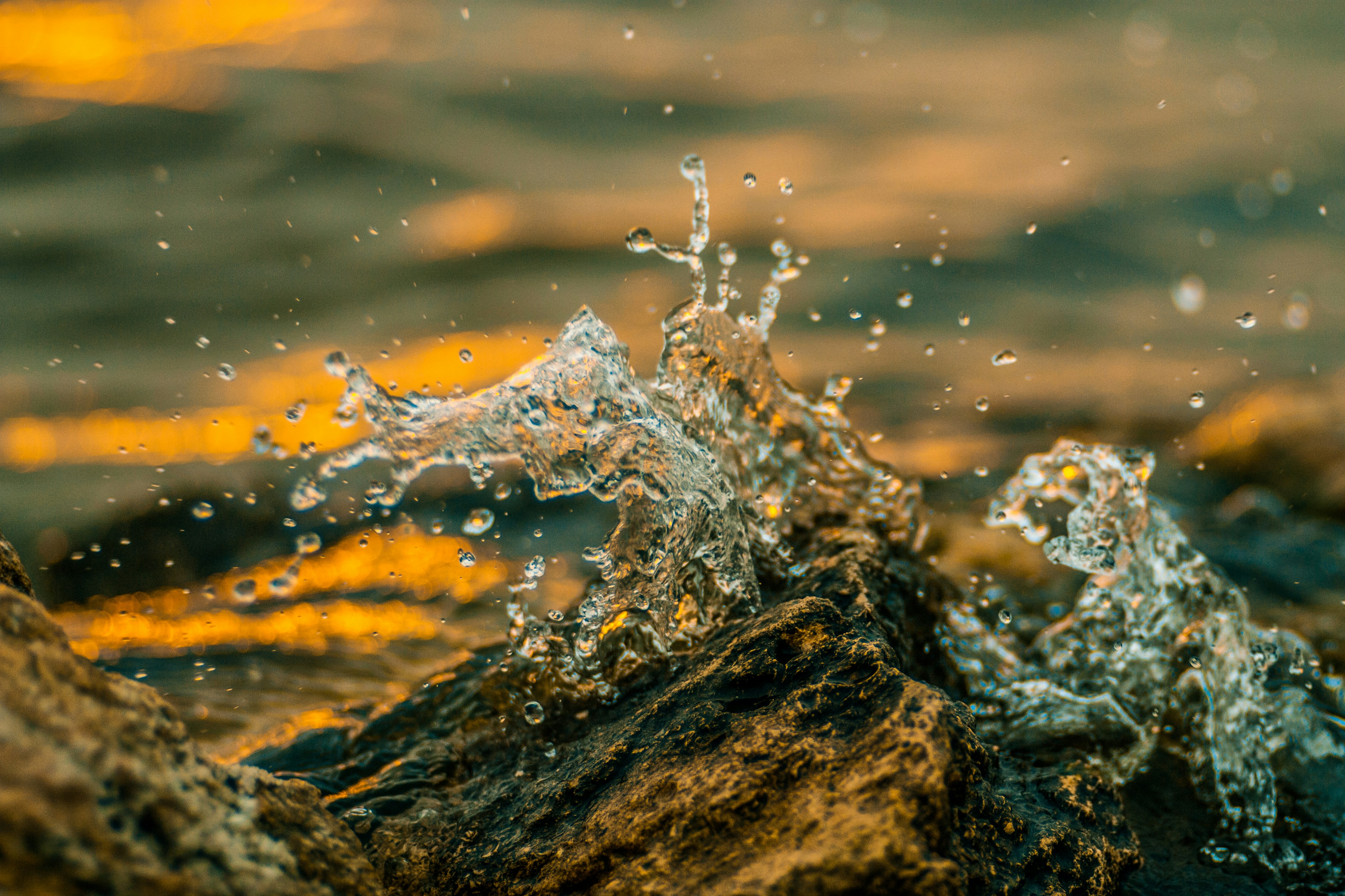 Sunlit Water Splash on Rocks