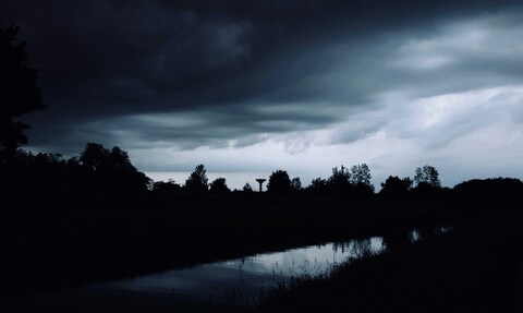 Storm Clouds Over Calm River