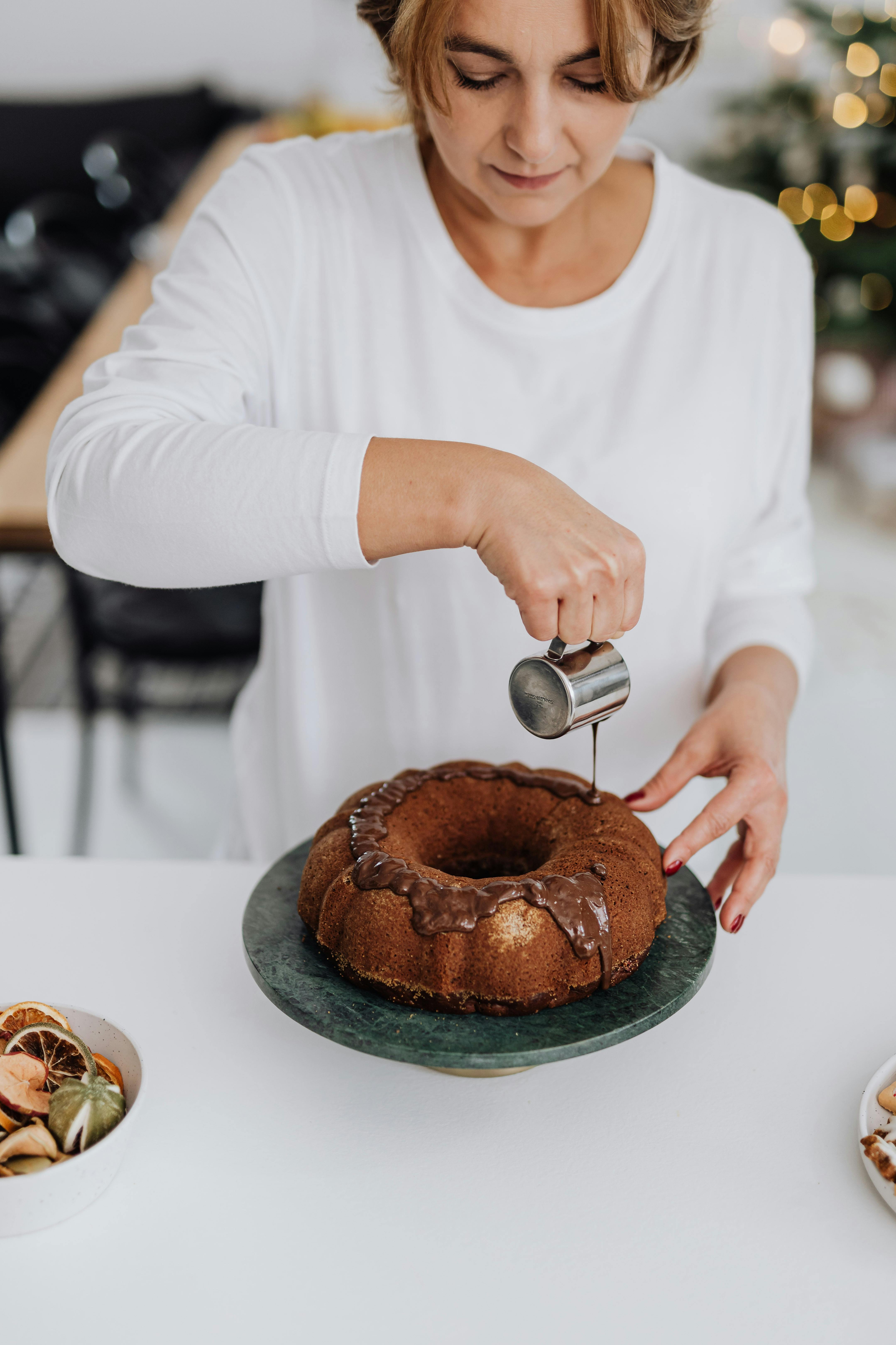 Woman Icing Chocolate Bundt Cake