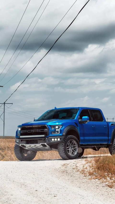 Blue Ford Raptor Pickup on Gravel Road