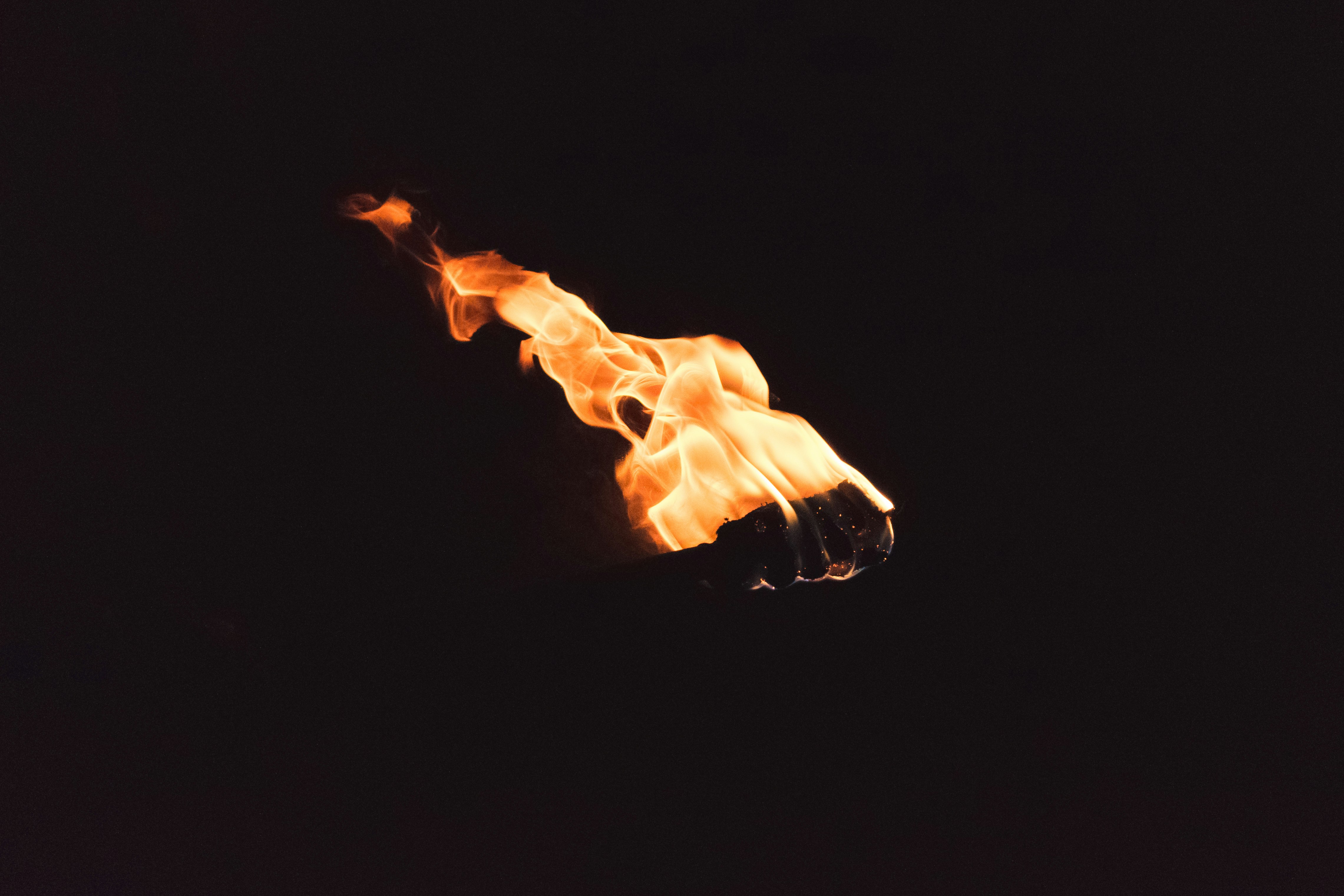 Burning Torch Against Dark Background