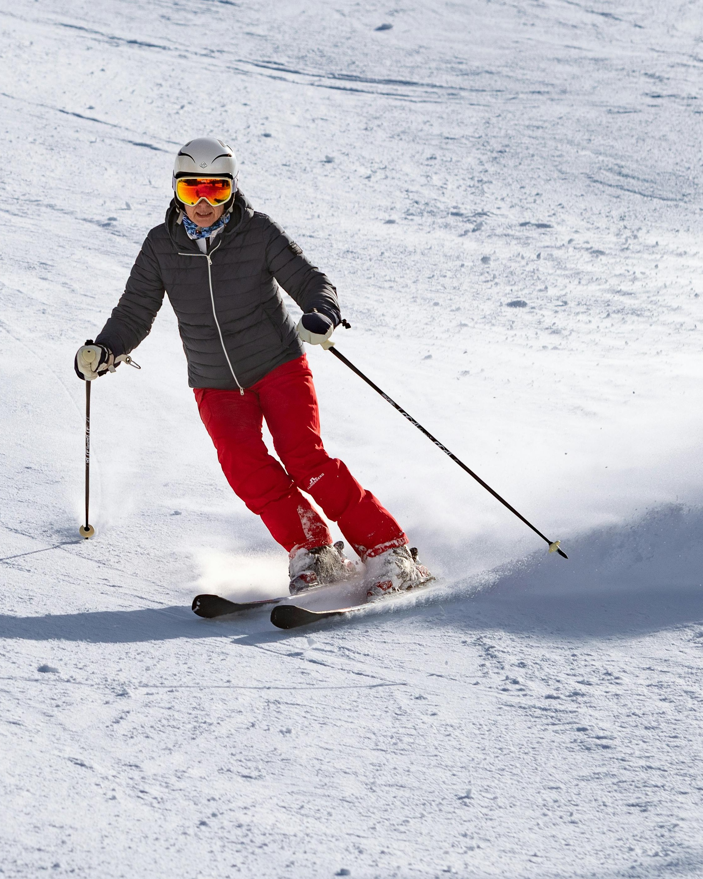 Skier Skiing Downhill on Snowy Slope