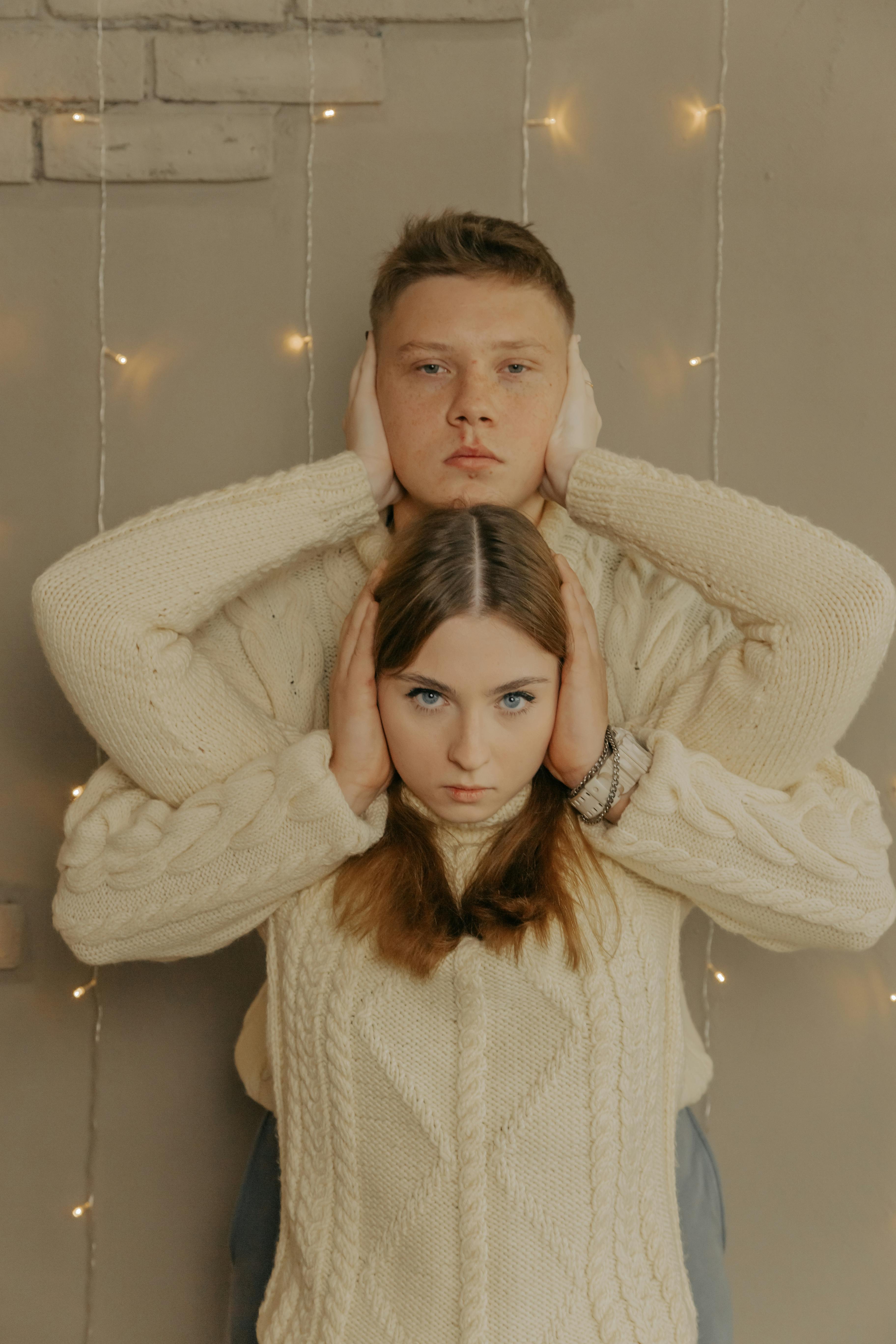 Young Couple Matching Pose Covering Ears