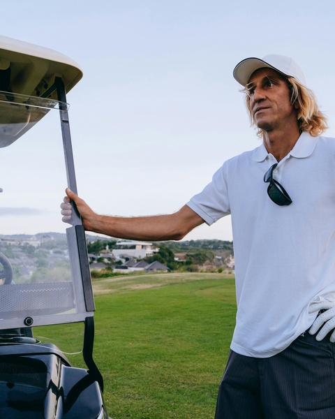 Golfer by Golf Cart on Golf Course