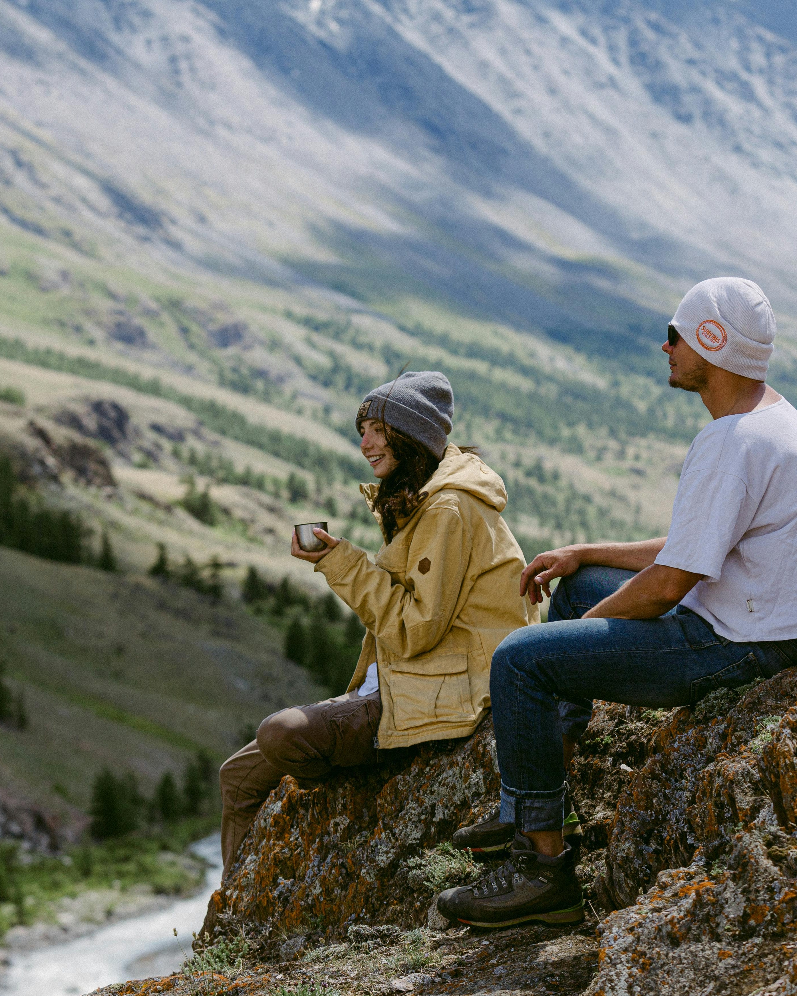 Two Hikers Resting on Mountain Overlook
