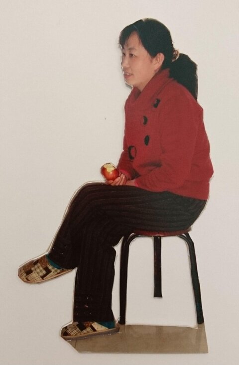 Woman Seated Holding A Bitten Apple