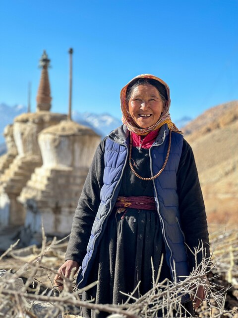 Smiling Woman Near Mountain Stupa