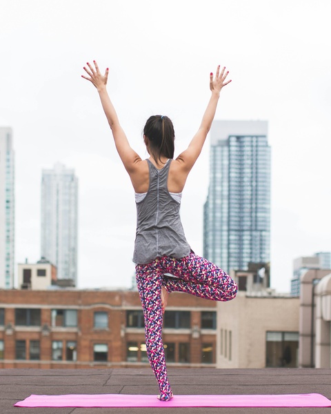 Woman Doing Yoga on Urban Rooftop