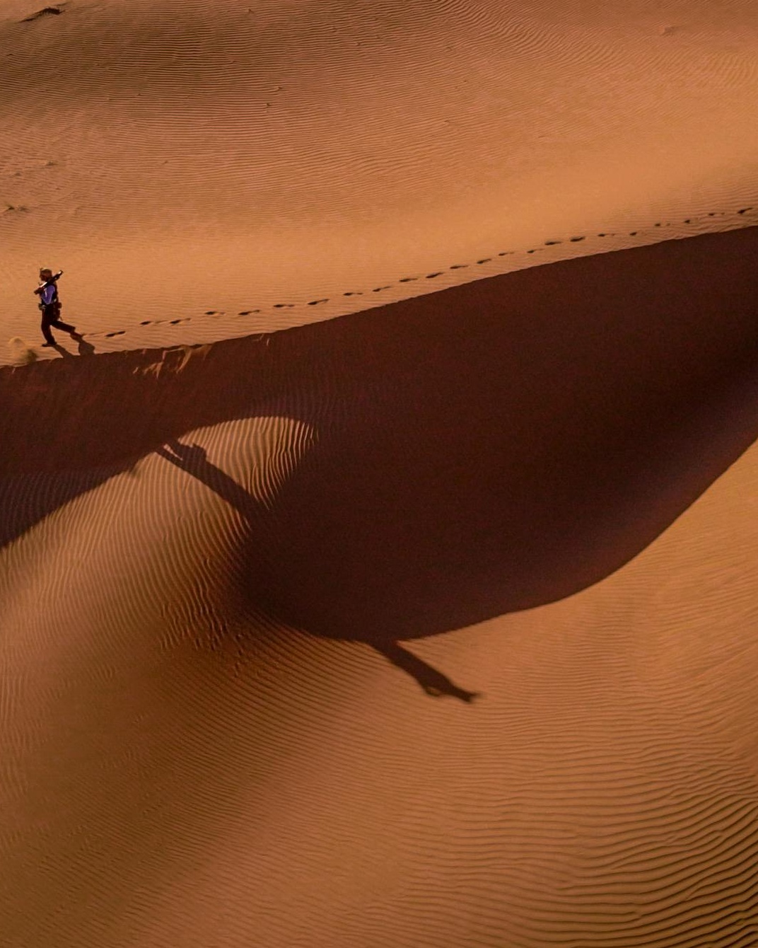 Lone Walker on Desert Sand Dunes